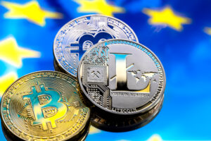 Coins Bitcoin And Litecoin, Against The Background Of Europe And The European Flag, The Concept Of Virtual Money, Close Up.